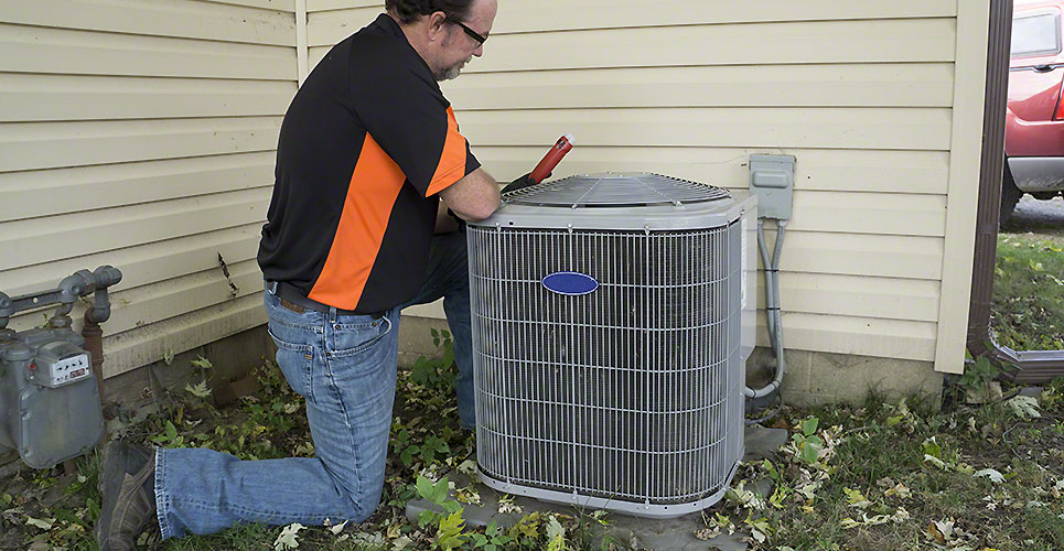 Repairman Checking Outside Air Conditioning Unit For Voltage DSI